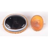 A banded agate Victorian high purity gold mounted brooch and a gold mounted intaglio brooch.