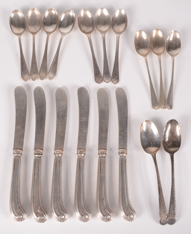 A set of six cake knives with filled silver handles, two Georgian feather edge silver spoons,