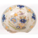 A Delft pottery barber's bowl, 18th century, decorated with a vase and stylised flowers, height 6.
