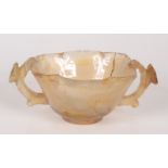 A Chinese agate twin handled cup, each handle decorated with a prunus blossom, height 3.