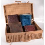 Six Victorian photograph albums and a wicker basket.