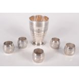 A set of five United Arab Emirates silver coloured metal napkin rings and an Art Deco style engine