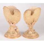 A pair of Royal Worcester blush ivory nautilus shell vases,