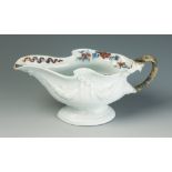 A Lunds Bristol porcelain sauce boat, circa 1750, with classic rococo design to the white exterior,