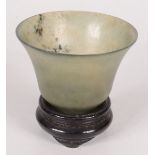 A Chinese jade bowl, 19th/20th century, with flared rim and footed base,