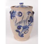 A German stoneware jar and cover, inscribed 'Rumtopf', with blue painted foliate decoration,