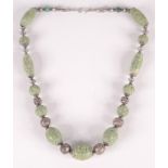 A Chinese carved jade and silver filigree bead necklace.