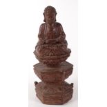 A South East Asian carved wood figure of a seated emperor, 19th century, height 30.5cm, width 11.