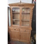 A Victorian pine bookcase, with a pair of glazed doors,