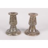 A pair of serpentine candlesticks, height 11cm.