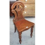 A Victorian oak hall chair.