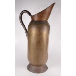 A large brass, floor standing jug, height 74cm, diameter 24.5cm.