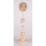 A Chinese ivory puzzle ball on stand, 19th century, the carved concentric ball carved with dragons,
