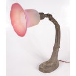 An Art Nouveau adjustable metal table lamp, with frosted pink glass shade, height 41cm.