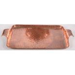 A Newlyn copper hammered, rectangular tray, with a pair of shaped handles, impressed 'Newlyn', 27.