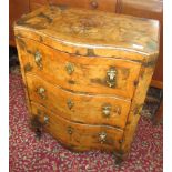 A continental burr walnut serpentine cupboard,