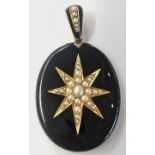 A Victorian mourning pendant in black onyx mounted with a pearl set gold star beneath a pearl set