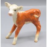 A Beswick figure of a calf, only marked England, height 9.7cm, width 10cm.