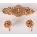 A Victorian 15ct gold bar brooch set a diamond and a pair of similar earrings.