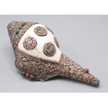 A Tibetan white metal mounted conch shell, the embossed decoration with animals, birds and foliage,