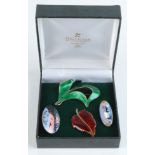 Four enamelled silver brooches.