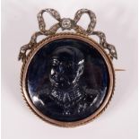 A sapphire cameo brooch, the military portrait beneath a diamond set ribbon.