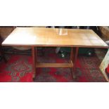 An Arts and Crafts oak dining table, the rectangular top on rectangular solid supports,