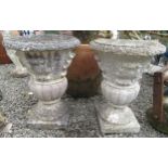 A pair of composition campana shaped garden urns, height 52cm, diameter 38cm.