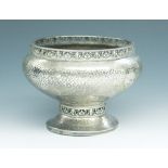 An A E Jones hammered silver rose bowl with chased pierced bands to the rim and stem,