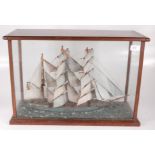 A wooden model of a sailing ship, early 20th century, in a glazed mahogany case, height 37.