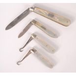 Two fruit knives with folding silver blades and two folding silver button hooks.