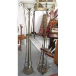 A pair of wrought iron standard lamps, with frosted glass shades, height 171.5cm.