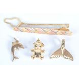 An 18ct three colour gold tie pin 5.9g, and three gold charms 3.9g.