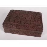 A Chinese cinnabar lacquer box and cover, carved with figures, pagodas, mountains,