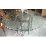 A contemporary circular dining table, the plate glass top on chromium plated cylindrical stand,
