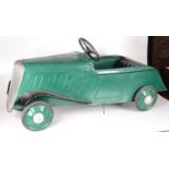 A green and black painted metal pedal car, height 45cm, length 104cm.