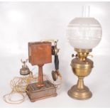 A Grammont Systeme Eurieul Paris telephone, height 33.5cm and a brass oil lamp, height 83cm.