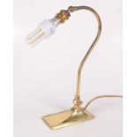 A brass adjustable table lamp, height 34.5cm, width of base 7.5cm, depth of base 15cm.