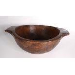 A treen twin handled bowl, height 16.5cm, width 44cm.