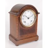 An inlaid mahogany mantle clock, early 20th century, the white enamel circular dial inscribed 'MFD.