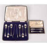 A pair of silver seafood forks, cased,