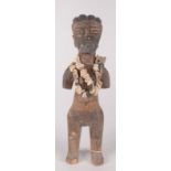 An African wood fertility figure of a naked woman, with a cowrie shell necklace, height 35cm,