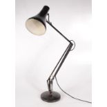 A black anglepoise lamp.