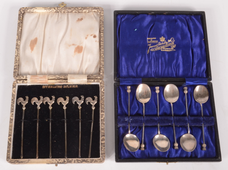 A set of six silver cocktail sticks with cockerel finials and a set of six silver coffee spoons