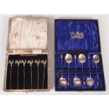A set of six silver cocktail sticks with cockerel finials and a set of six silver coffee spoons