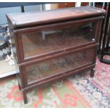 A Globe Wernicke oak glazed bookcase, with two sections, on stile feet, with makers label,