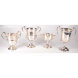 Four twin handled silver cups, 35.7oz.