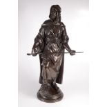 A bronze figure of an arab carrying a rifle, late 19th/early 20th century,