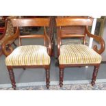 A pair of carving chairs with scrolling arms and turned legs.