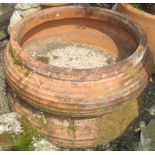 A pair of large terracotta planters, height 23cm, diameter 66cm.